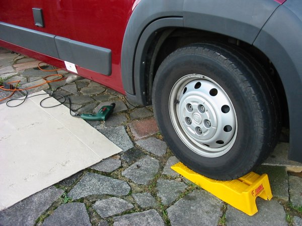 pic showing van raised up on ramps